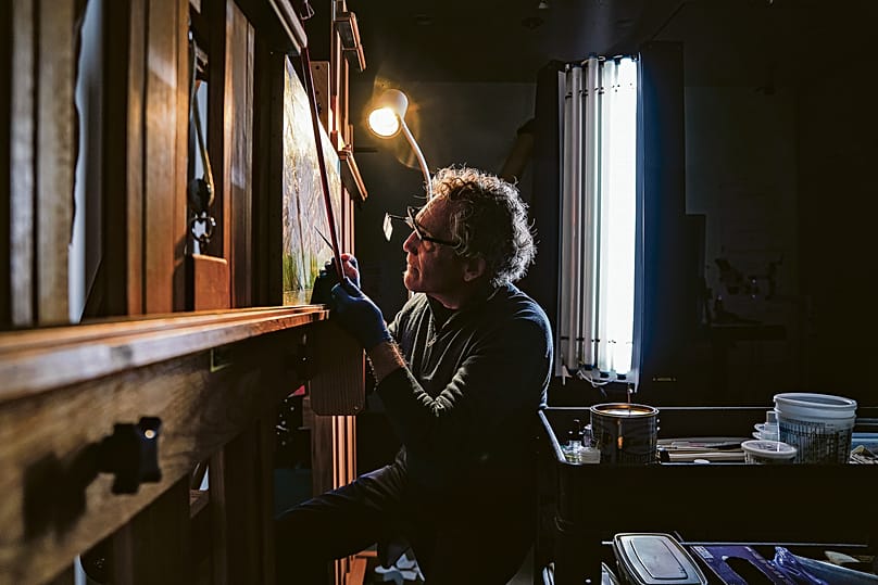 Dale Kronkright, head of conservation for the Georgia O'Keefe Museum, inspects a Georgia O'Keeffe oil on canvas painting in Santa Fe, New Mexico.