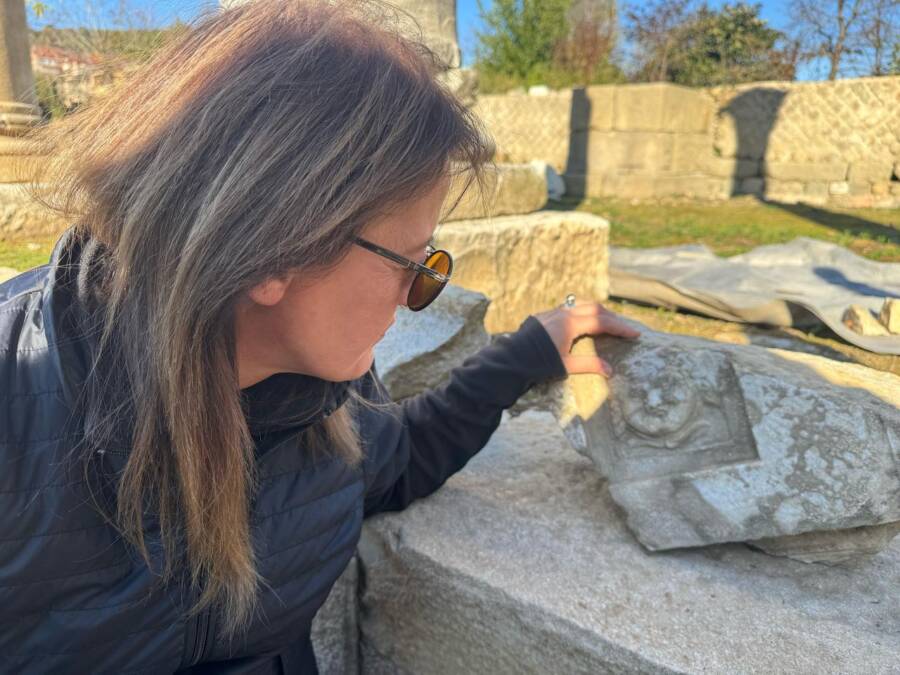 Archaeologist With Medusa Carving