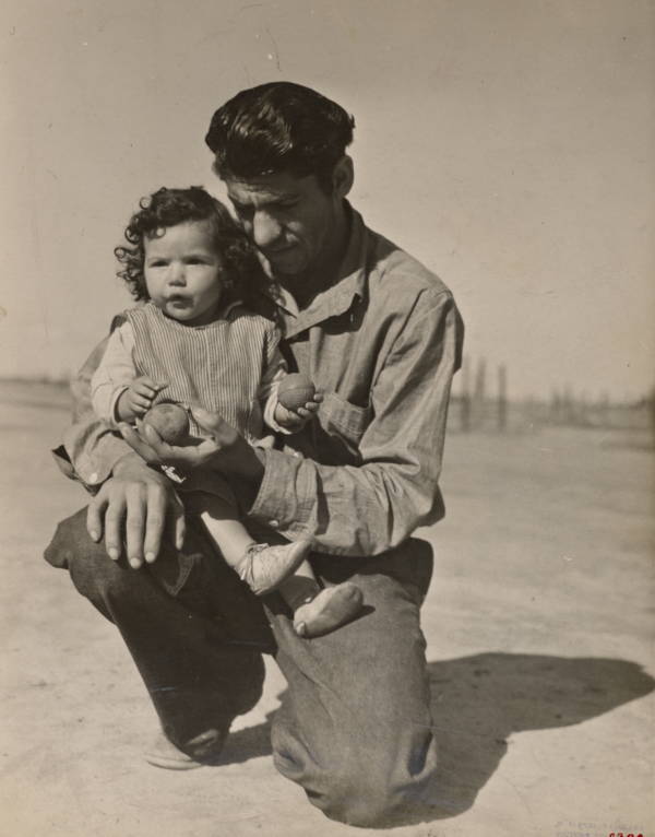 Man Kneeling Holding Child