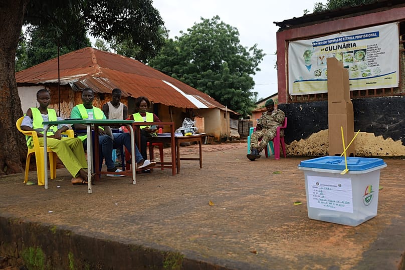 Election officials wait for voters to cast their ballots