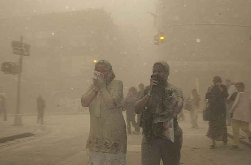 People were forced to flee as the streets around lower Manhattan were covered in a thick ash after the twin towers collapsed. 11 September, 2001.