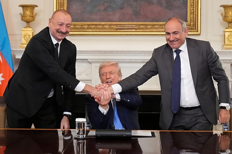 President of Azerbaijan, Ilham Aliyev and PM of Armenia, Nikol Pashinyan shake hands as US President Donald Trump sits between them, 8 August 2025