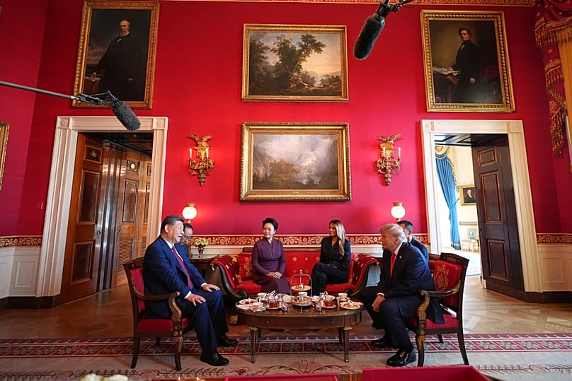 US President Donald Trump speaks with China's President Xi Jinping on the steps of the National Archives Museum in Washington, 25 September, 2026