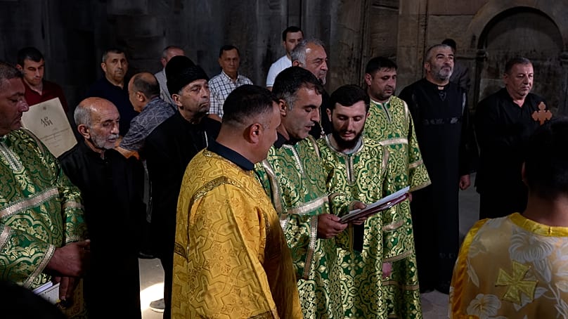 The congregation and clergy gathered at the church, with church officials in green, gold, and black vestments, in Gandzasar, 21 September 2026