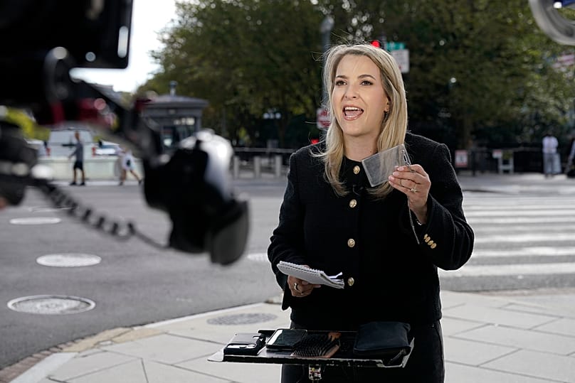 CNN White House Reporter Betsy Klein holding up an empty card holder