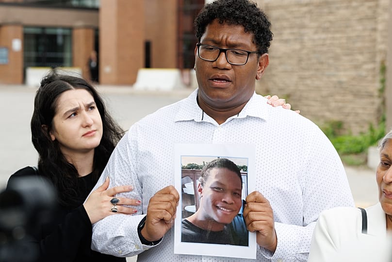 Family member holding photo of victim
