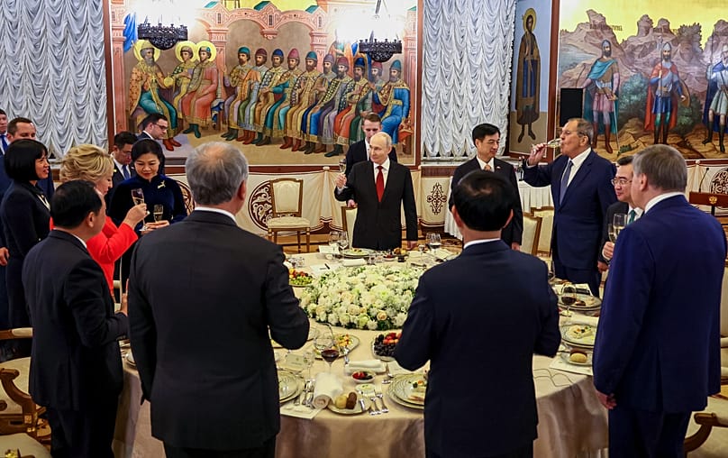 Vladimir Putin raises a toast during a state dinner in honour of Vietnamese President To Lam